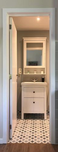 a bathroom with a sink and a mirror at Le Pavillon in Céroux-Mousty