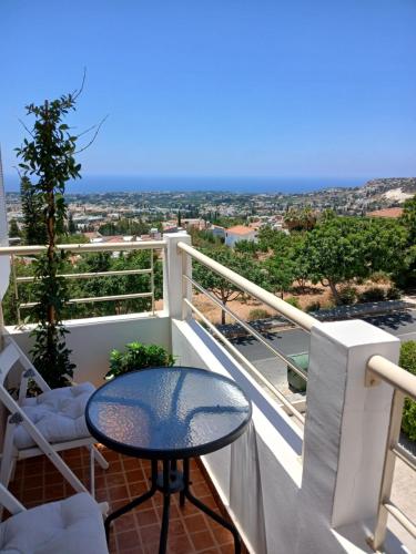 a balcony with a table and a view of the city at Seaview Holiday Studio Peyia in Peyia