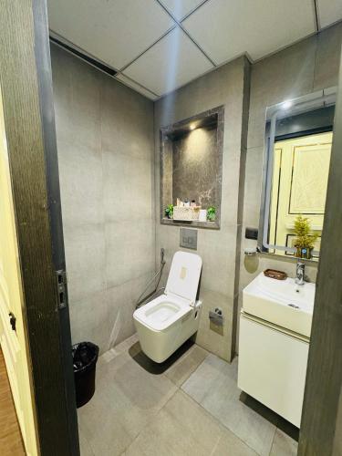 a small bathroom with a toilet and a sink at Spira Supernova in New Delhi
