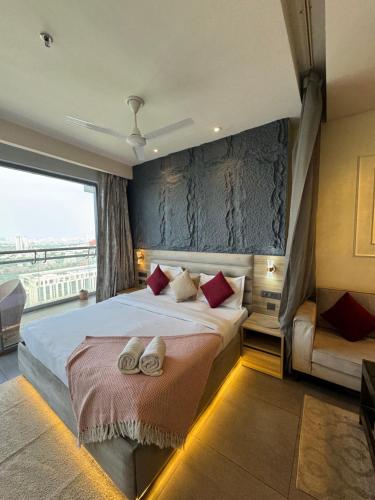 a bedroom with a large bed with red pillows at Spira Supernova in New Delhi