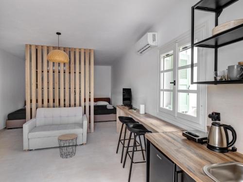 a kitchen and living room with a couch and a table at Βlue Lagoon G6 in Galissas