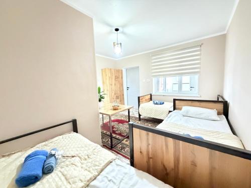 a bedroom with two beds in a room at Like House Karakol in Karakol