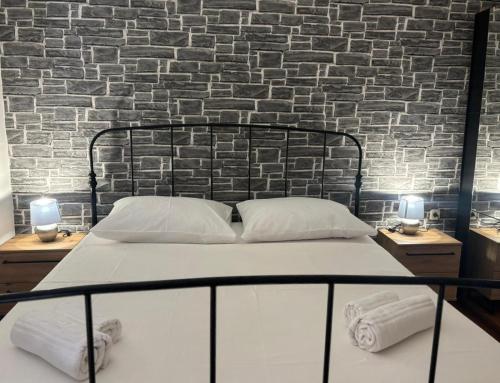 a bed in a room with a brick wall at Cozy apartment Ivana in Gornji Karin