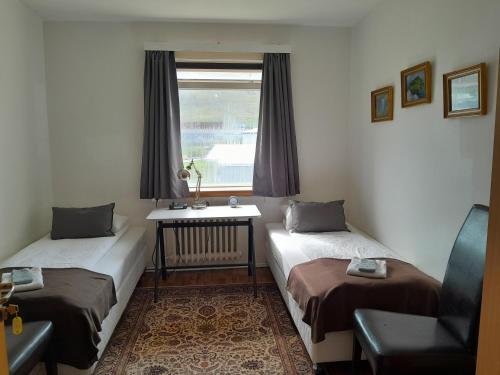 a room with two beds and a window at Guesthouse in Ólafsvík