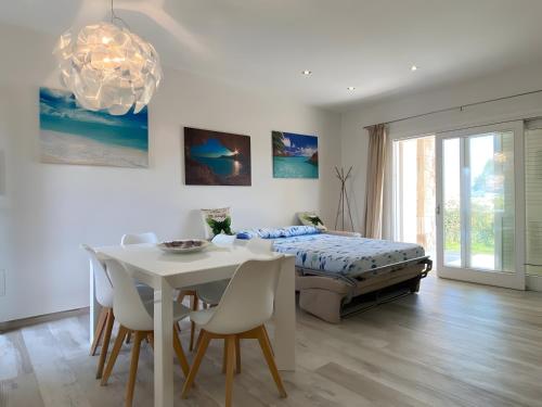 a bedroom with a bed and a table and chairs at R House II - Puntocasabudoni in Budoni