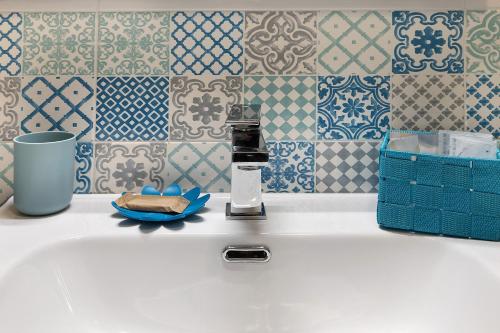 a bathroom sink with a soap dispenser on it at Quercia -in Caruggiu di Via Vecchia in Orco Feglino