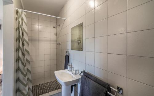 a bathroom with a sink and a mirror at The 3rd Leg Bed and Breakfast in Pennington