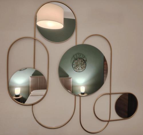 a group of mirrors hanging on a wall at Vlll PORTICO in Bologna