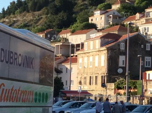 a group of cars parked in a parking lot at Main Bus Terminal Rooms in Dubrovnik