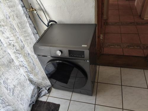 a washing machine in the corner of a room at The Museum in Sabie