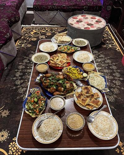 a table filled with different types of food at White Desert Experience in Bawati