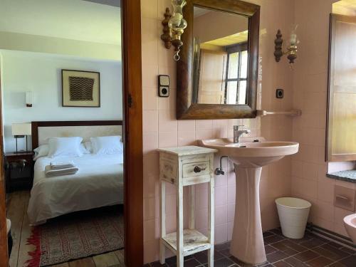 a bathroom with a bed and a sink and a mirror at R2R - Finca Ranapega - 34A03 in Escamprero