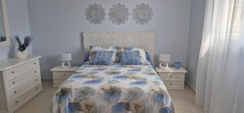 a bedroom with a bed and two night stands at Une Belle Histoire in Argelliers