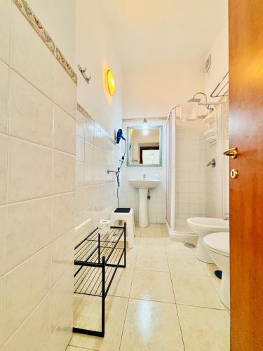 a white bathroom with a toilet and a sink at Il Rifugio Di Ela con 2 appartamenti in Furore