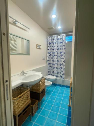 a bathroom with a sink and a toilet at La casa di Giulia in Genoa