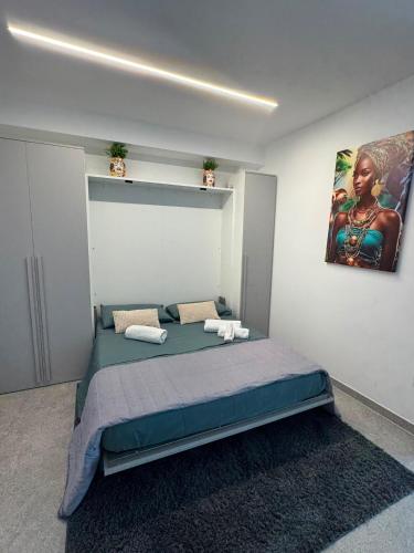 a bedroom with a bed and a painting on the wall at Occhi sul mare in Termoli