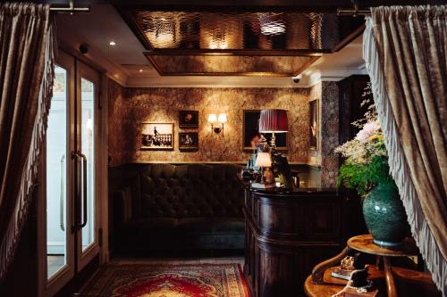 a living room with a couch and a table at Hotel Pigalle in Gothenburg