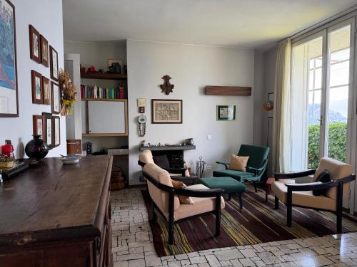 a living room with a table and chairs at Villa 64 in Fiumelatte