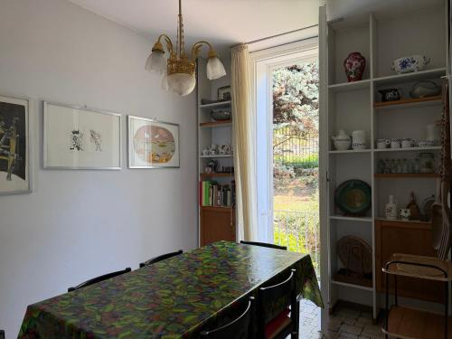 a dining room with a table and a window at Villa 64 in Fiumelatte