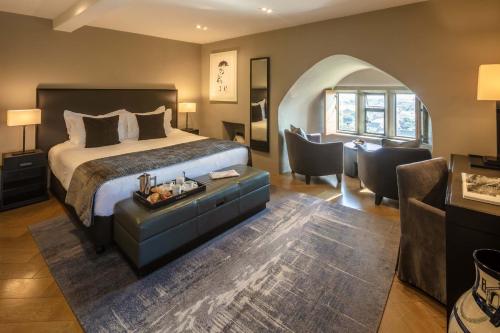 a bedroom with a bed and a table and chairs at Roch Castle in Roch