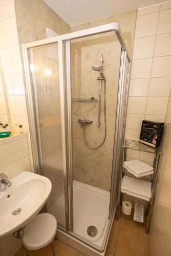 a bathroom with a shower and a sink at Appartementhaus Anne in Binz