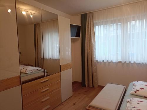 a bedroom with a dresser and a mirror at Beim Orgeler in Fügen