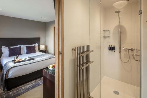 a hotel room with a bed and a shower at Roch Castle in Roch