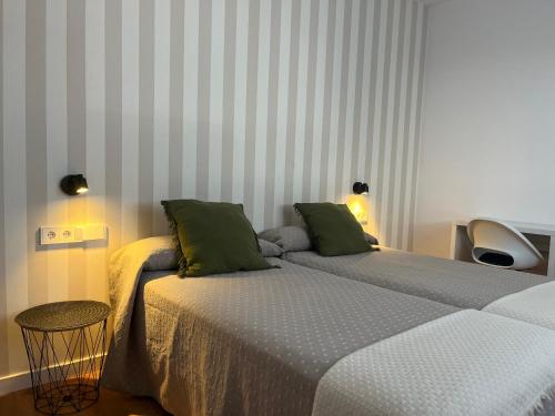 two beds sitting next to each other in a room at Apartamento Xogo da Ola En el camino De Santiago in Porriño