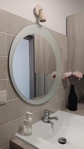 a bathroom with a sink and a mirror at Areos de Cabío in A Pobra do Caramiñal