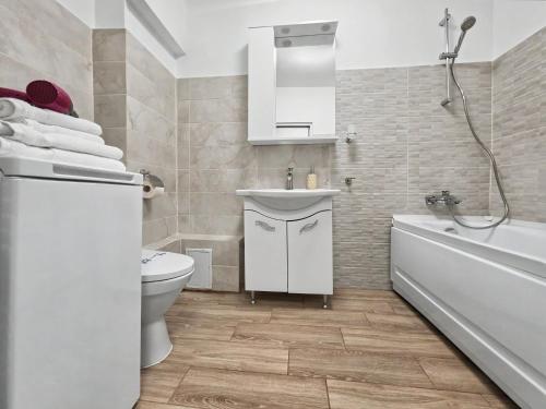 a bathroom with a toilet and a sink and a tub at Konstanzer12 - Free Parking Apt - AC in Iaşi
