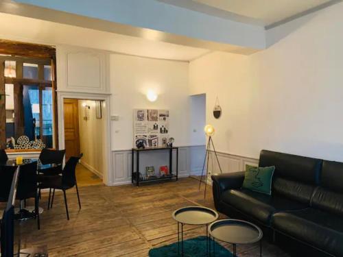 a living room with a couch and a table at Aube berges de Troyes in Troyes
