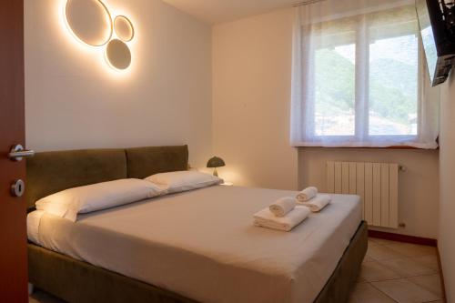 a bedroom with a bed with two towels on it at Lake Iseo Panorama Suite in Tavernola Bergamasca