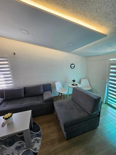 a living room with a couch and a table at Apartments Horizont Mostar in Mostar