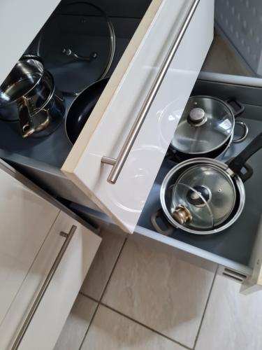 a kitchen with a stove with two pans in it at Selafa Carma in Mühlhausen