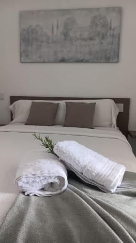 a white bed with a pillow on top of it at Areos de Cabío in A Pobra do Caramiñal