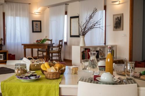 a table with a green table cloth and fruits on it at Oasi Picolit in Povoletto