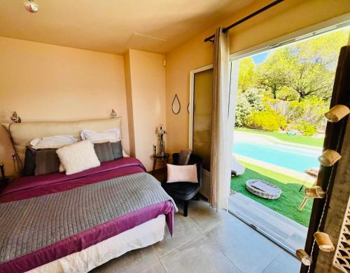a bedroom with a bed and a sliding glass door at Les Villas MarInCelu in Porto Pollo