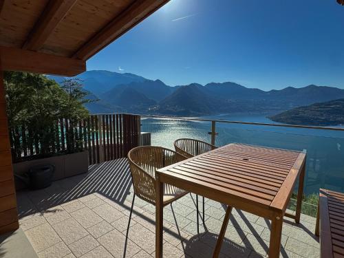 a wooden table and chairs on a balcony with a view at Le Sirene in Parzanica