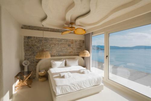 a bedroom with a bed with a view of the water at YU Townhouse in Bodrum City