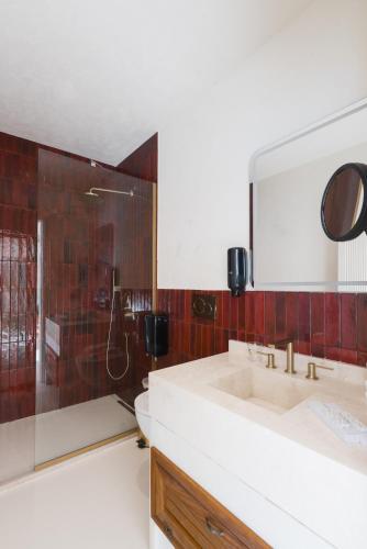a bathroom with a sink and a shower at YU Townhouse in Bodrum City
