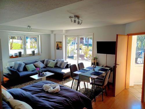 a living room with a couch and a table at TauberGenuss in Werbach