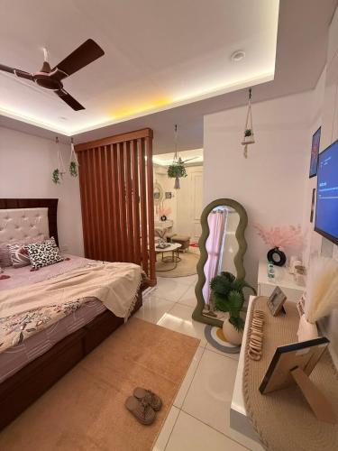 a bedroom with a bed and a tv and a couch at Flippy Escapes in Zirakpur