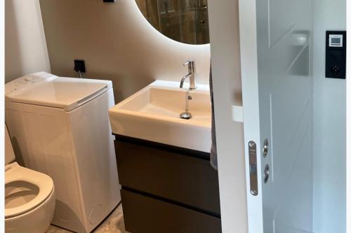 a bathroom with a sink and a toilet at Studio Sleeps 2 Sollentuna centre in Sollentuna