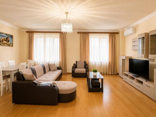 a living room with a couch and a tv at Republic Square Apartment in Yerevan