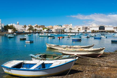 a group of boats are docked in a harbor at Avocado Corner House - Charco de San Gines By Lanzarote Vacation Homes in Arrecife