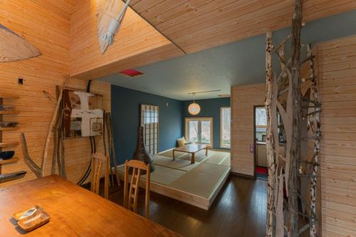 a living room with a wooden ceiling and a dining room at Kussharoko Artemina Lotus in Teshikaga