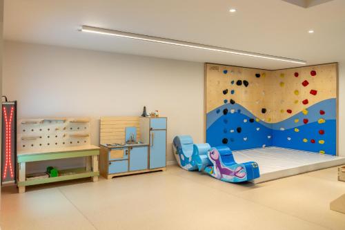 a room with a bedroom with a rock wall at Lagoona by Isrotel Collection in Eilat