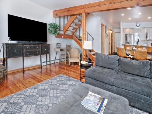 a living room with a couch and a flat screen tv at Ptarmigan Townhomes 30 in Vail