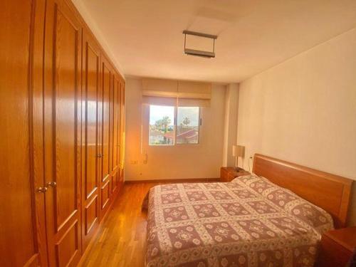 a bedroom with a bed and a window at Terra marina in Grao de Castellón