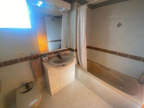 a bathroom with a toilet and a sink and a tub at Terra marina in Grao de Castellón
